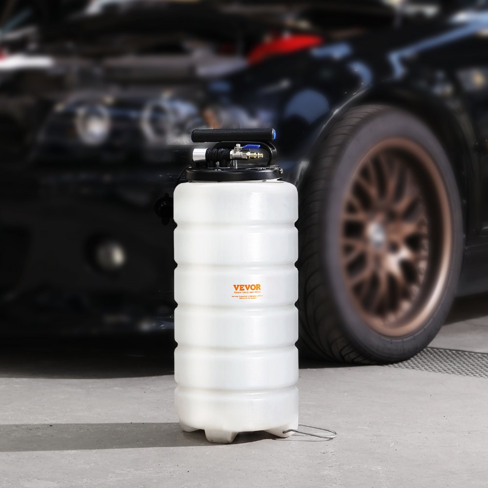 VEVOR fluid extractor in a garage with a parked black car in the background.