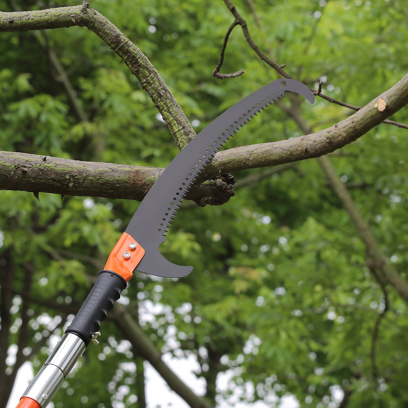 pole saw cutting tree branch in a lush green environment, VEVOR manual pole saw.