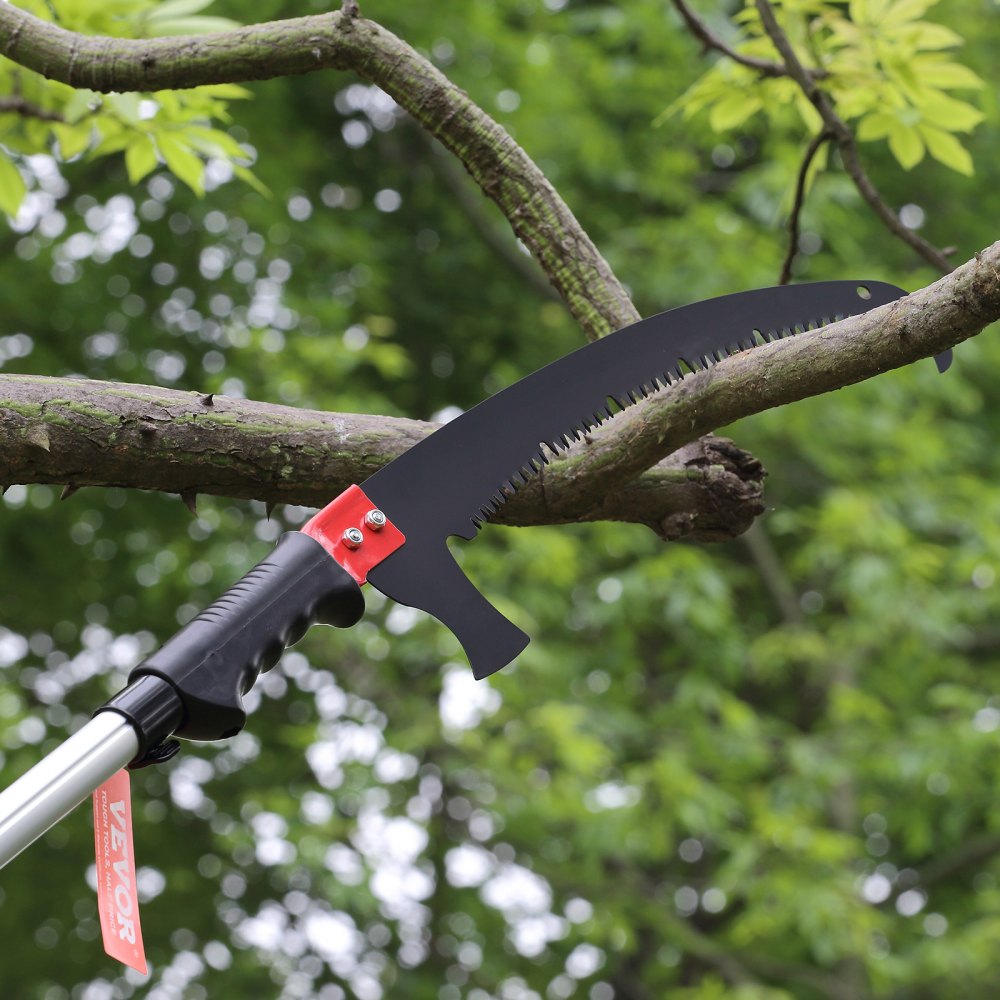 VEVOR manual pole saw cutting a tree branch with green foliage in the background.