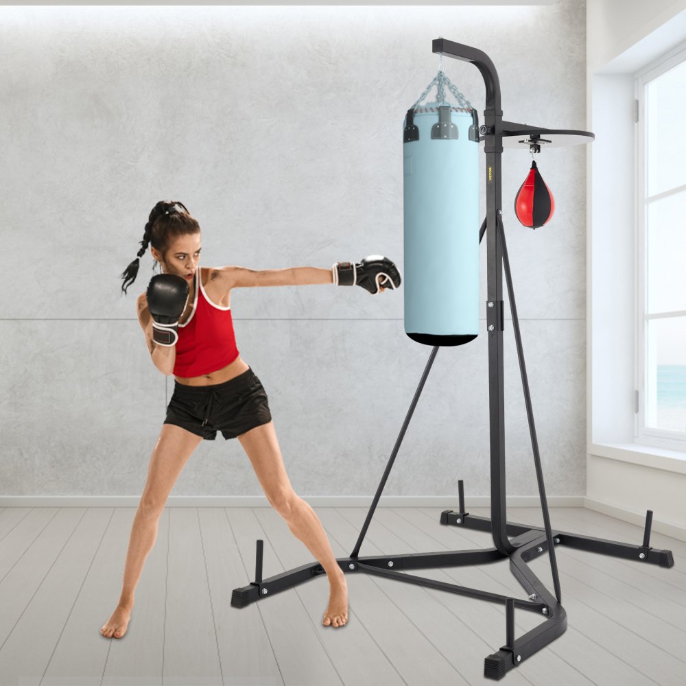 boxer training on VEVOR heavy bag stand in a bright room with ocean view.