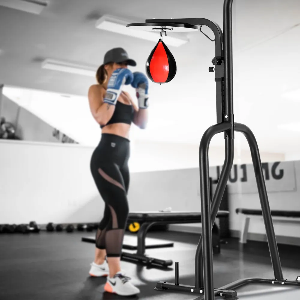 woman training with boxing gloves near VEVOR punching bag stand in a gym setting.