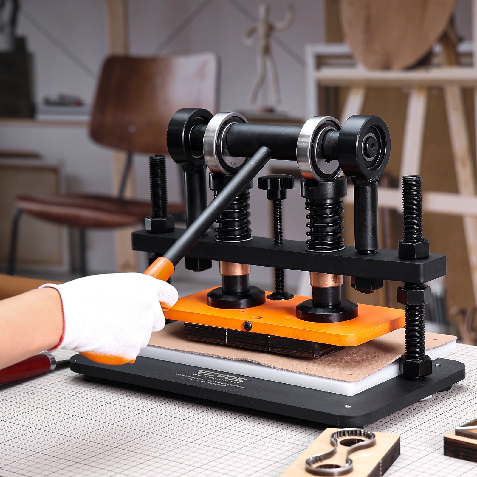 VEVOR leather cutting machine in a workshop, operated by a person wearing a white glove.