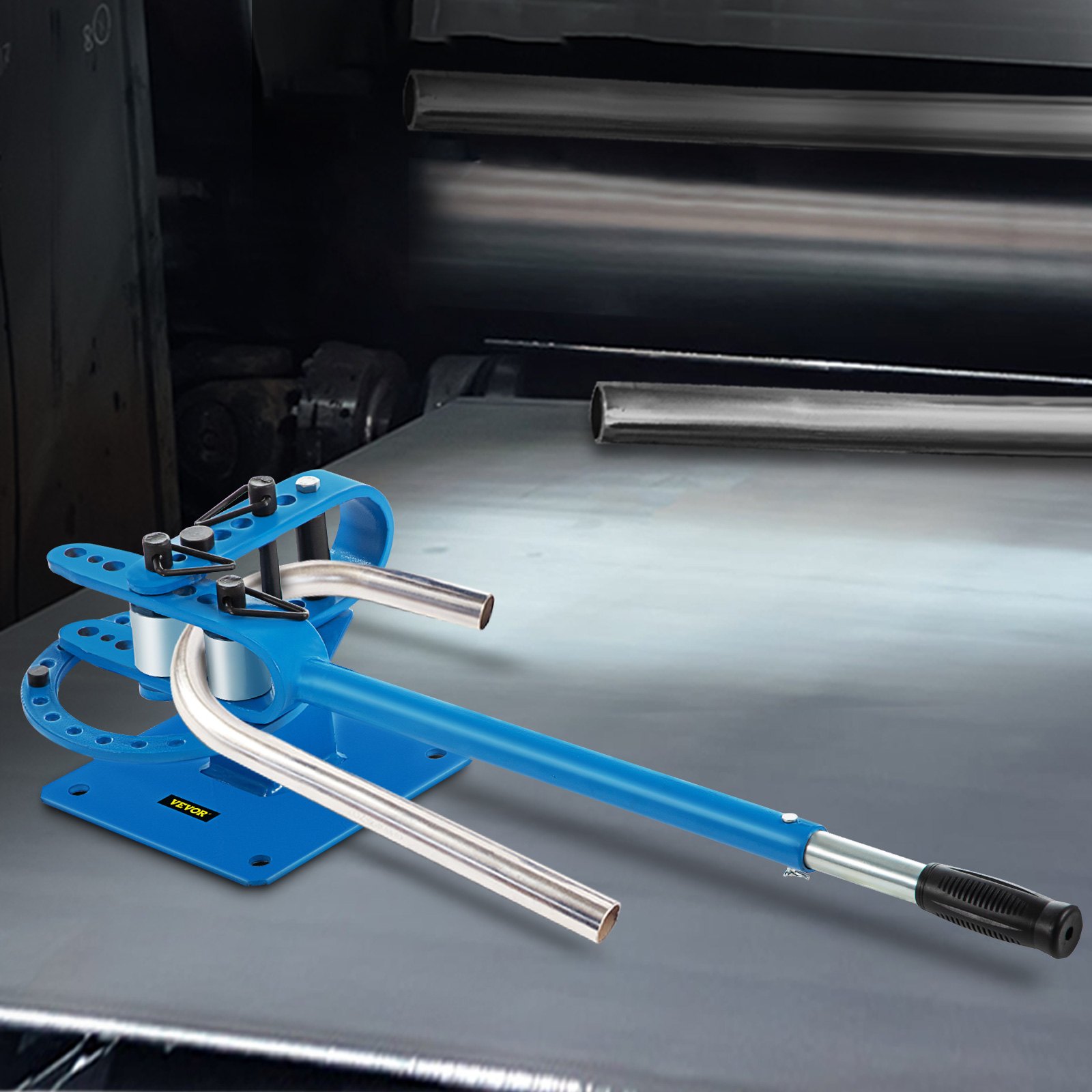 VEVOR metal bender on a metal surface with pipes in the background.