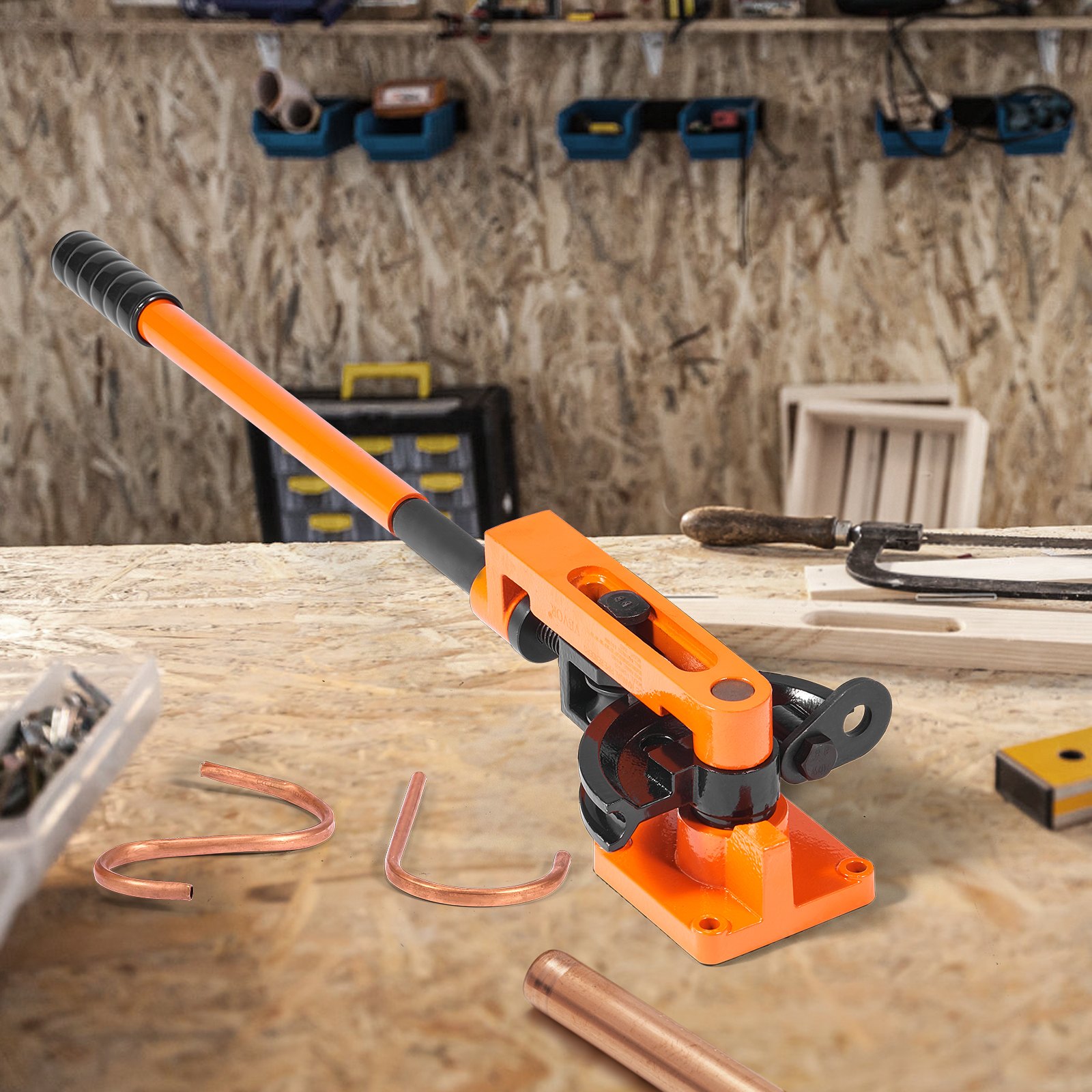 VEVOR pipe bender on a workbench with bent copper pipes, hand tools, and organized workshop background.
