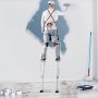 painter on VEVOR drywall stilts painting a wall, surrounded by painting supplies on the floor.