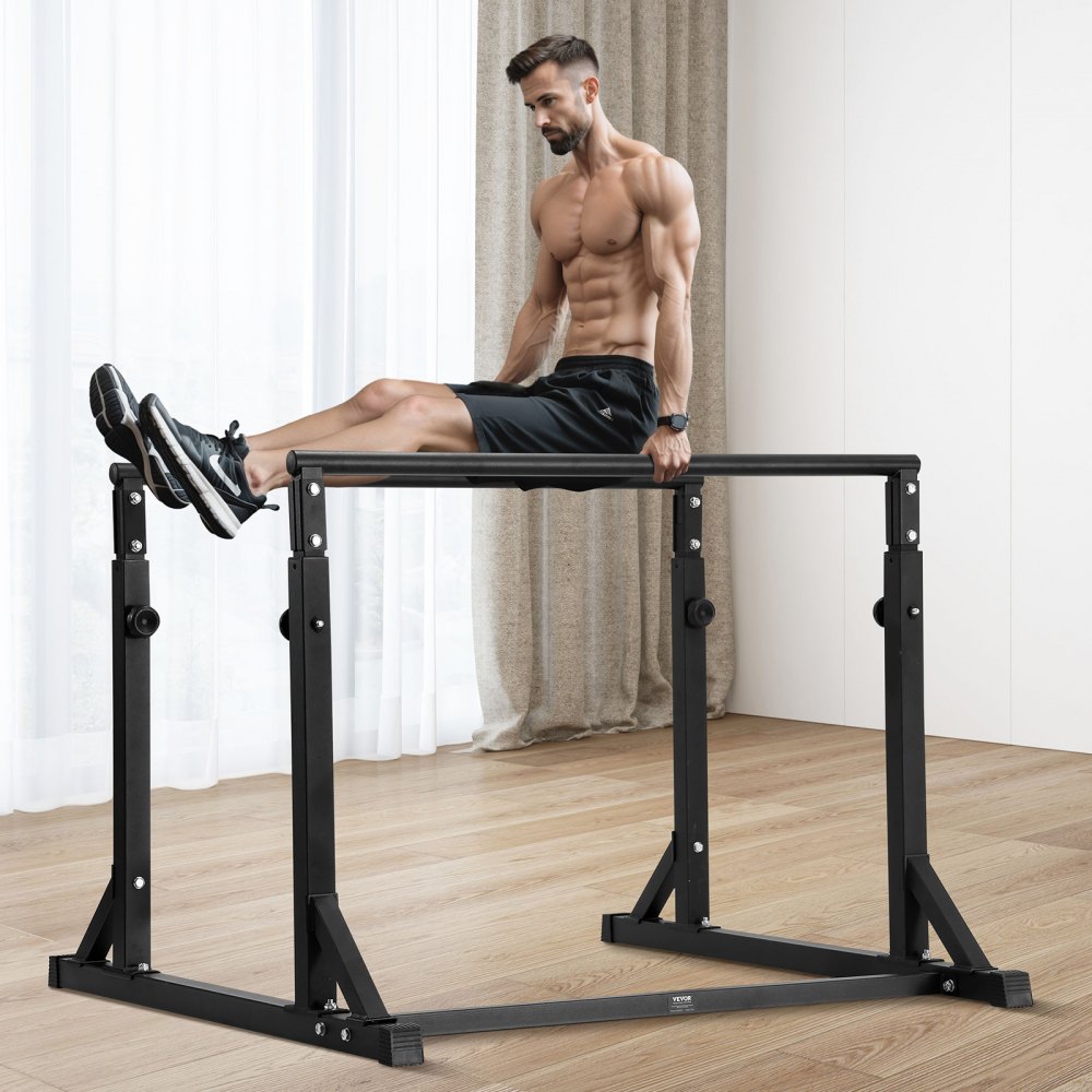 man performing an l-sit using a VEVOR dip bar in a bright, minimalistic home gym.