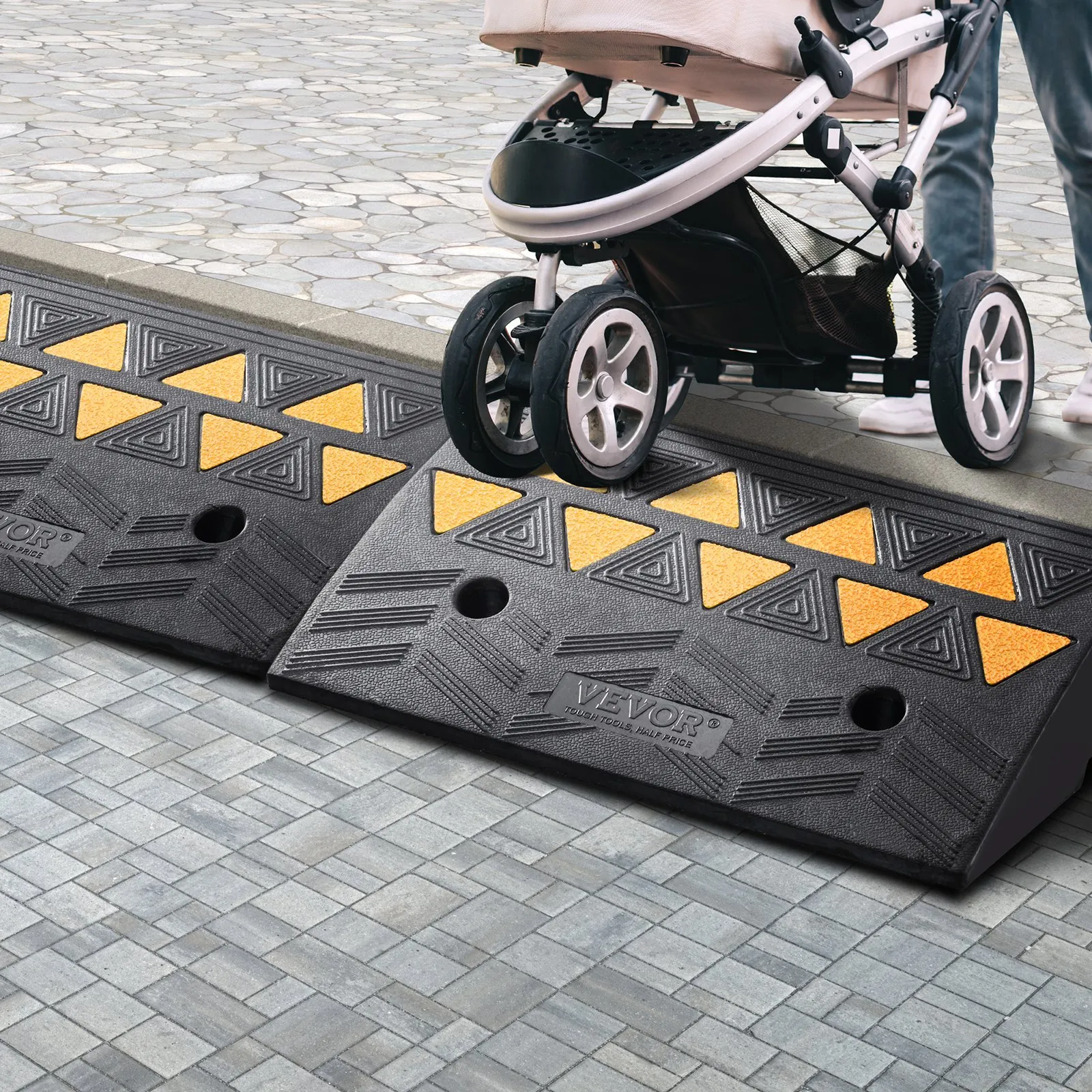 VEVOR rubber curb ramp aiding stroller transition on pavement with yellow triangle pattern.