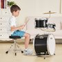 child playing VEVOR kids drum set in a cozy living room with white furniture and wooden floor.
