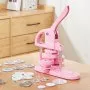 pink VEVOR button maker on a wooden table with various button parts scattered around.
