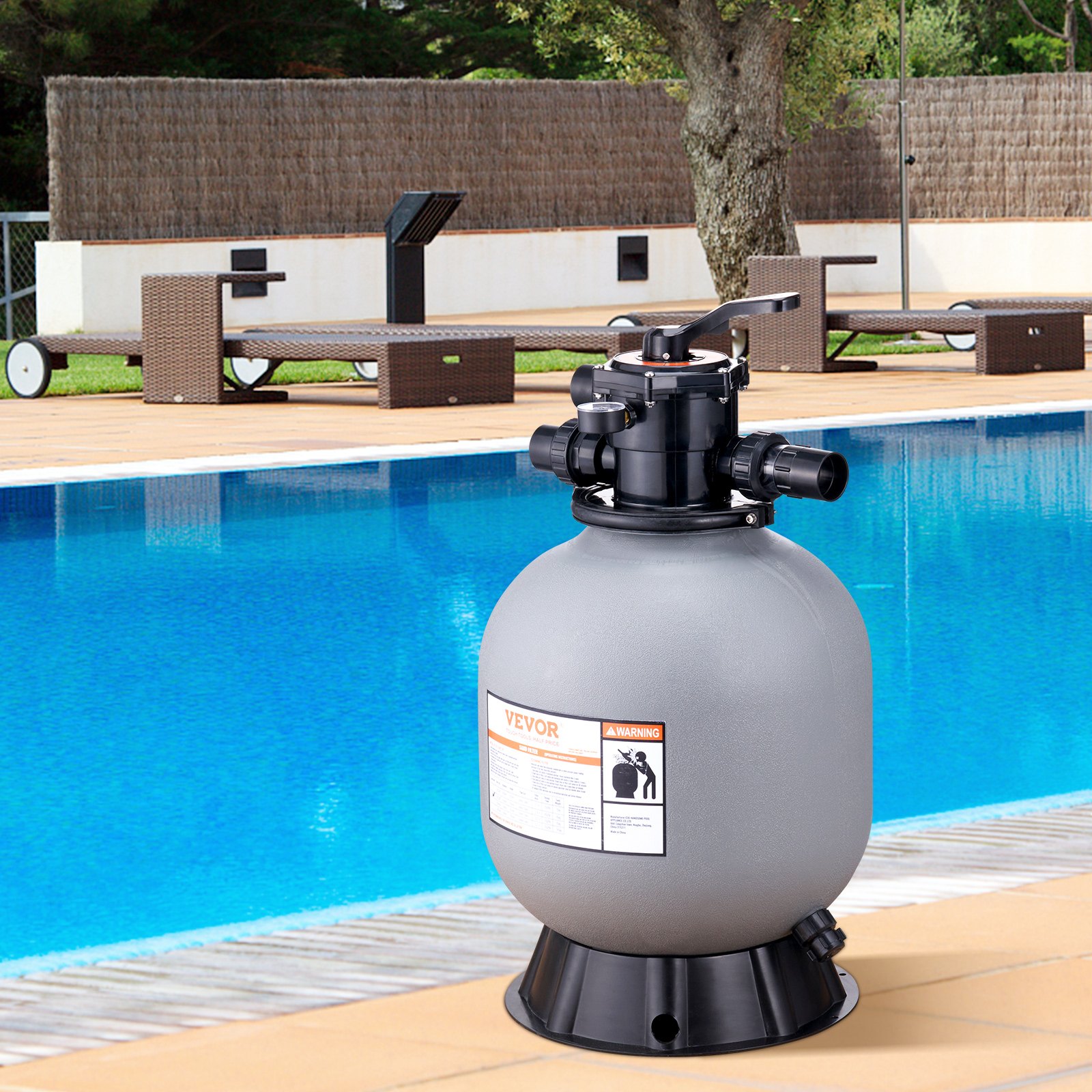 VEVOR sand filter system beside a clear blue pool with lounge chairs and greenery in the background.