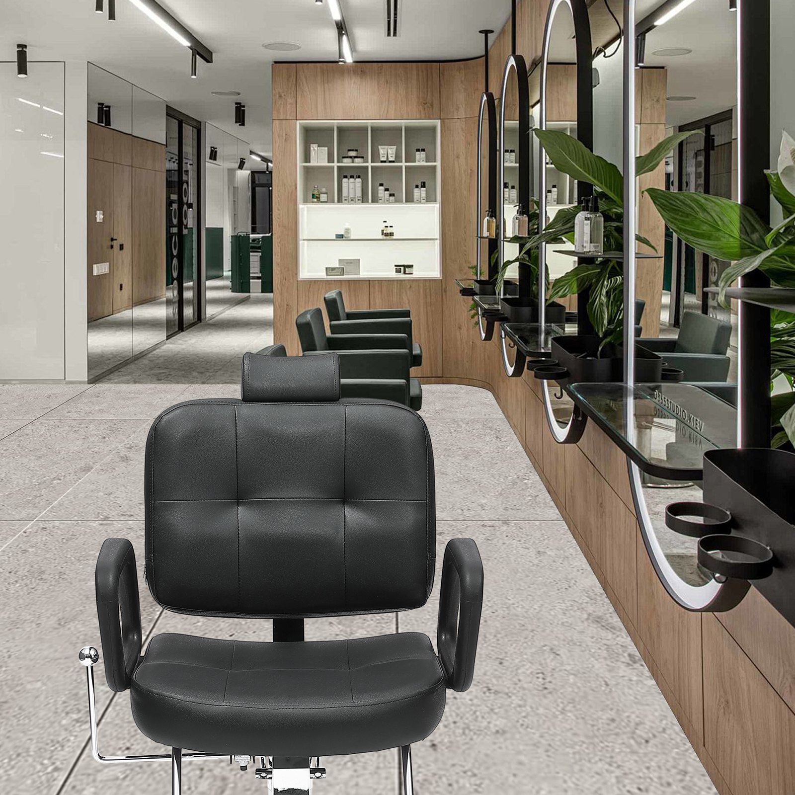 black VEVOR salon chair in a modern salon with wood panel decor and large circular mirrors.