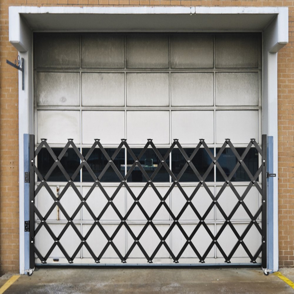 VEVOR security gate in front of a garage door on a brick building.