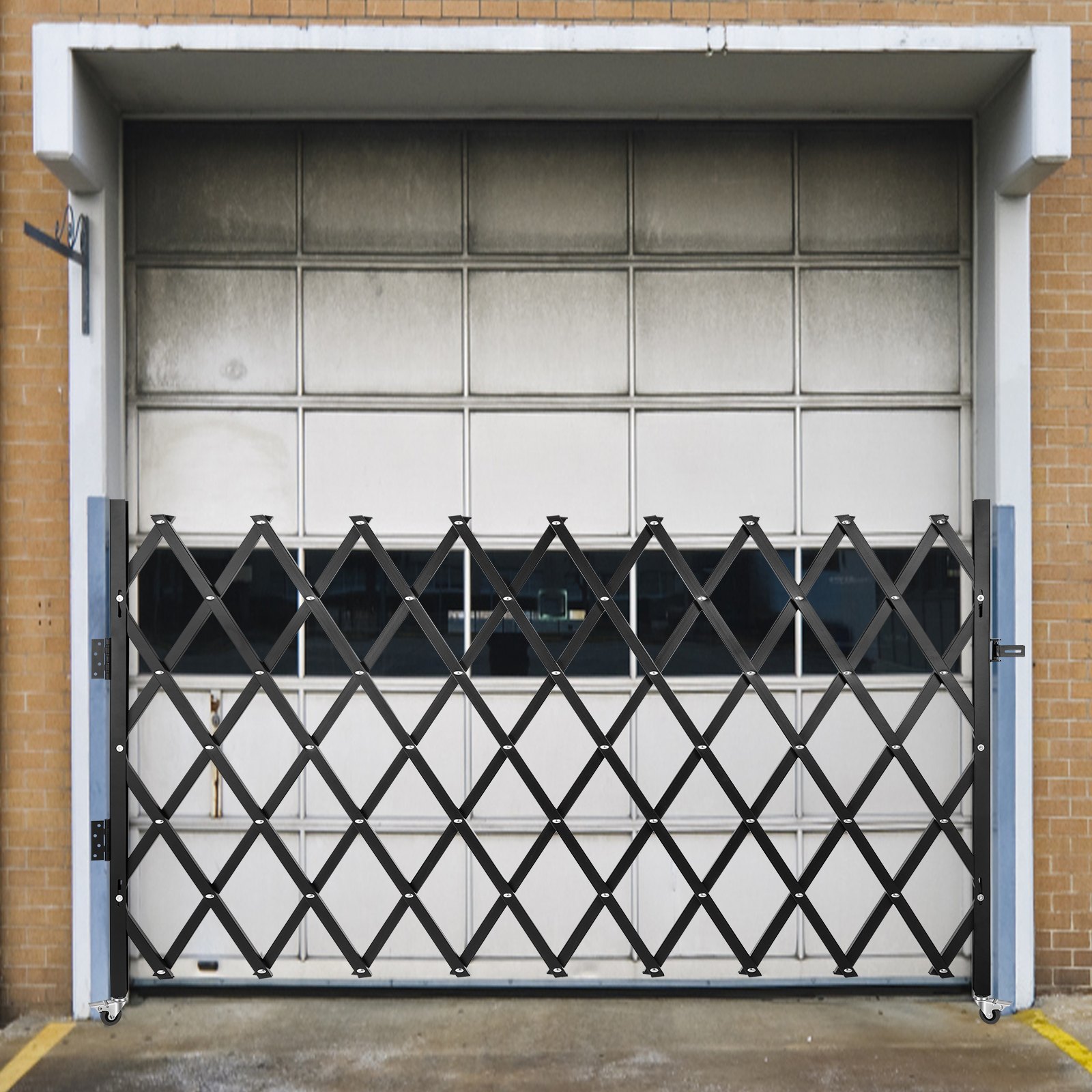 VEVOR security gate in front of a garage door on a brick building.
