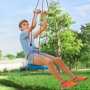 child enjoying a VEVOR zip line kit in a sunny park with green trees in the background.