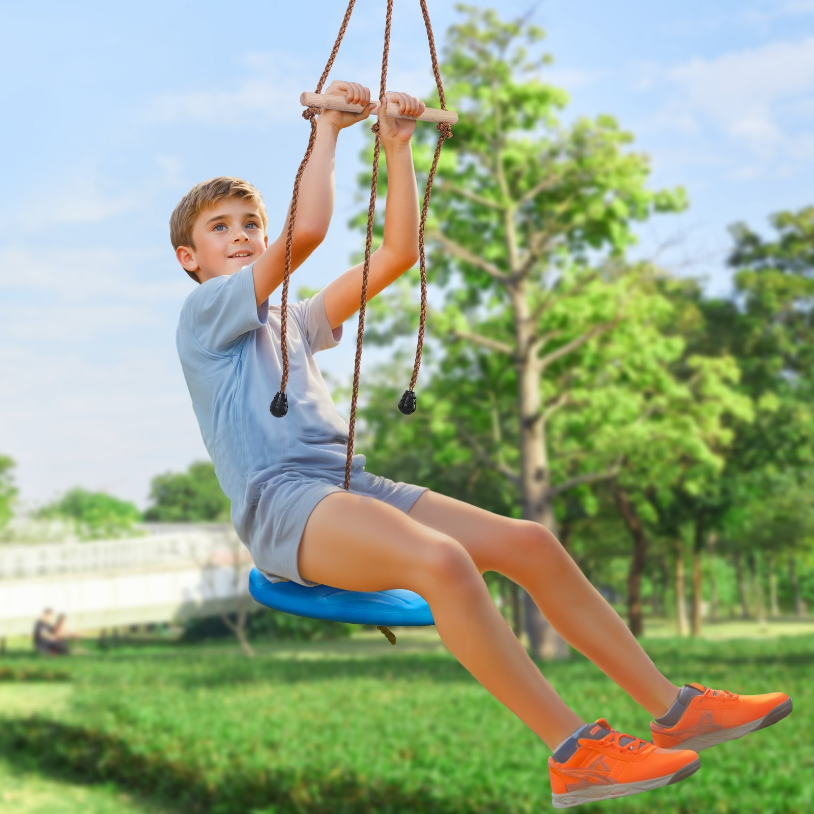 child enjoying a VEVOR zip line kit in a sunny park with green trees in the background.