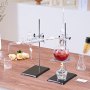 VEVOR essential oil distillation kit shown on a wooden table with glassware and flowers nearby.