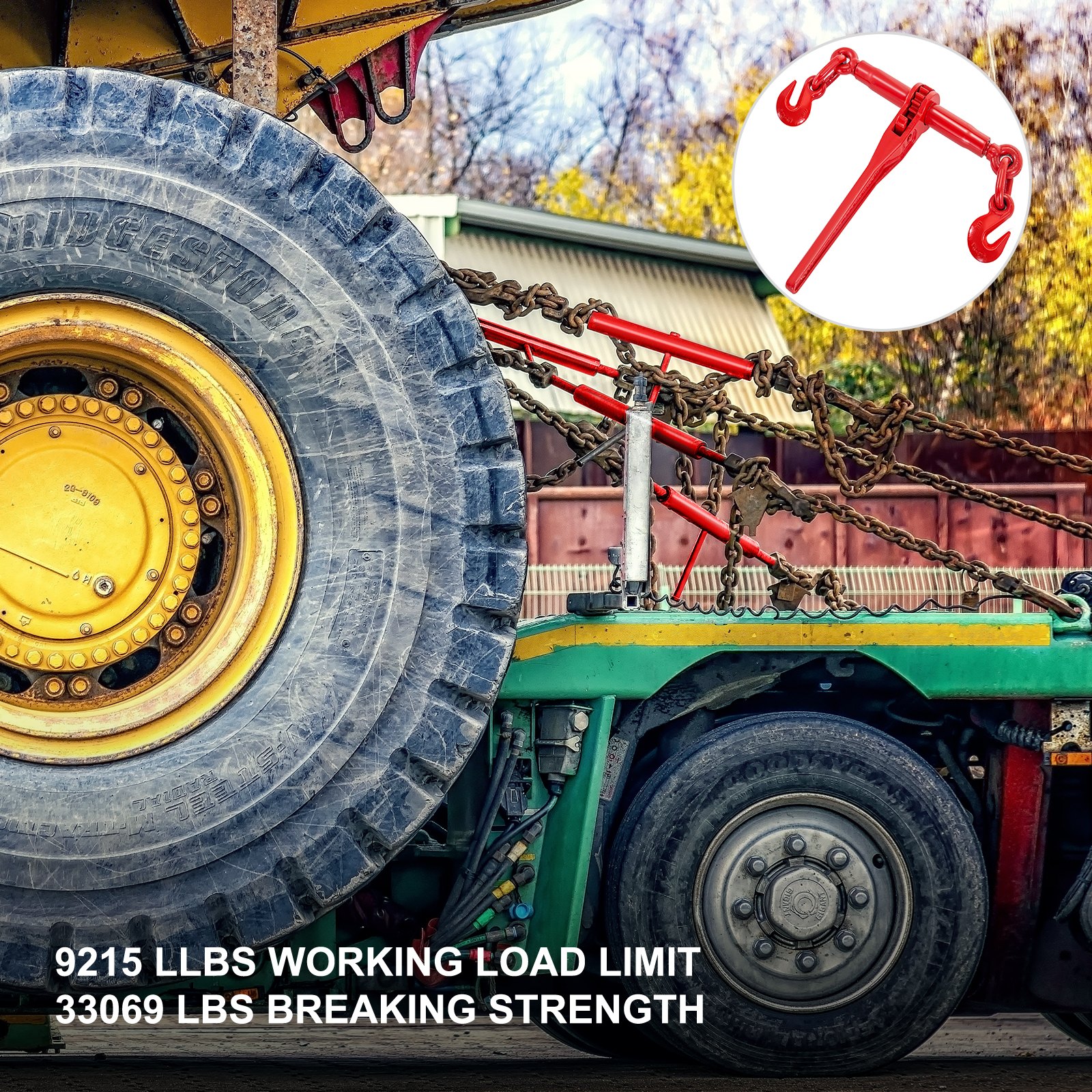VEVOR ratchet binders securing heavy machinery with chains on a green trailer.