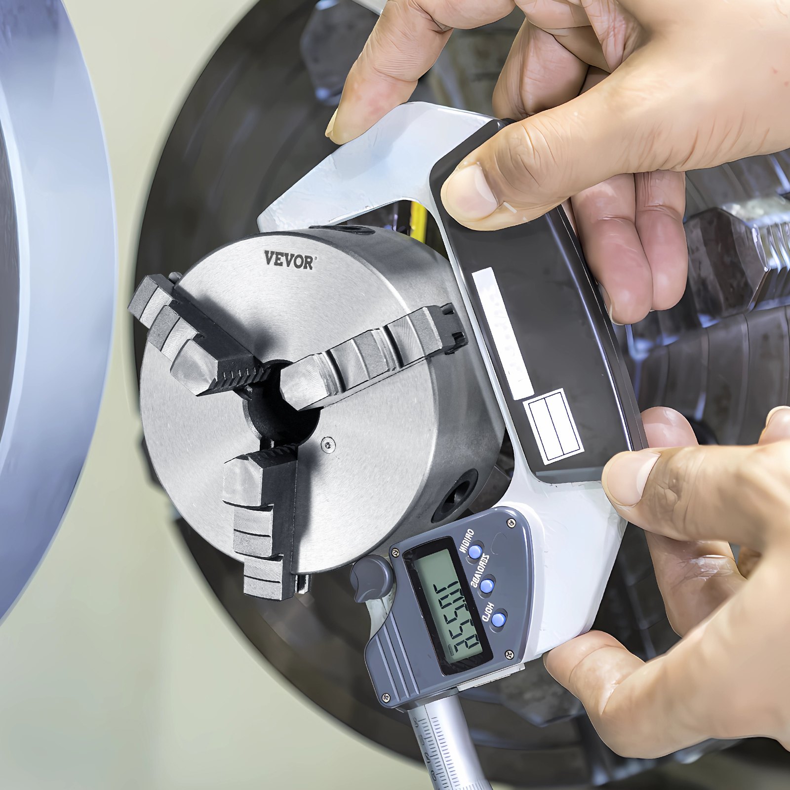 hands using a caliper to measure a VEVOR 3-jaw lathe chuck attached to a lathe.