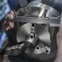 caliper measuring VEVOR 3-jaw lathe chuck during precision engineering work.