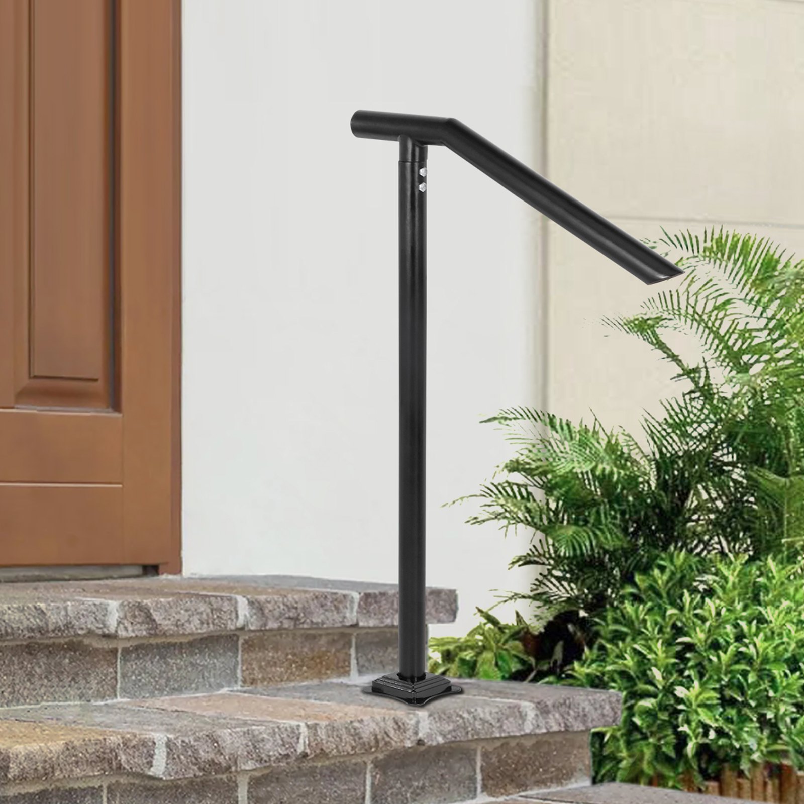 black VEVOR step railing on stone steps with greenery in the background.