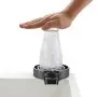 hand pressing a bottle on the VEVOR glass rinser over a sink.