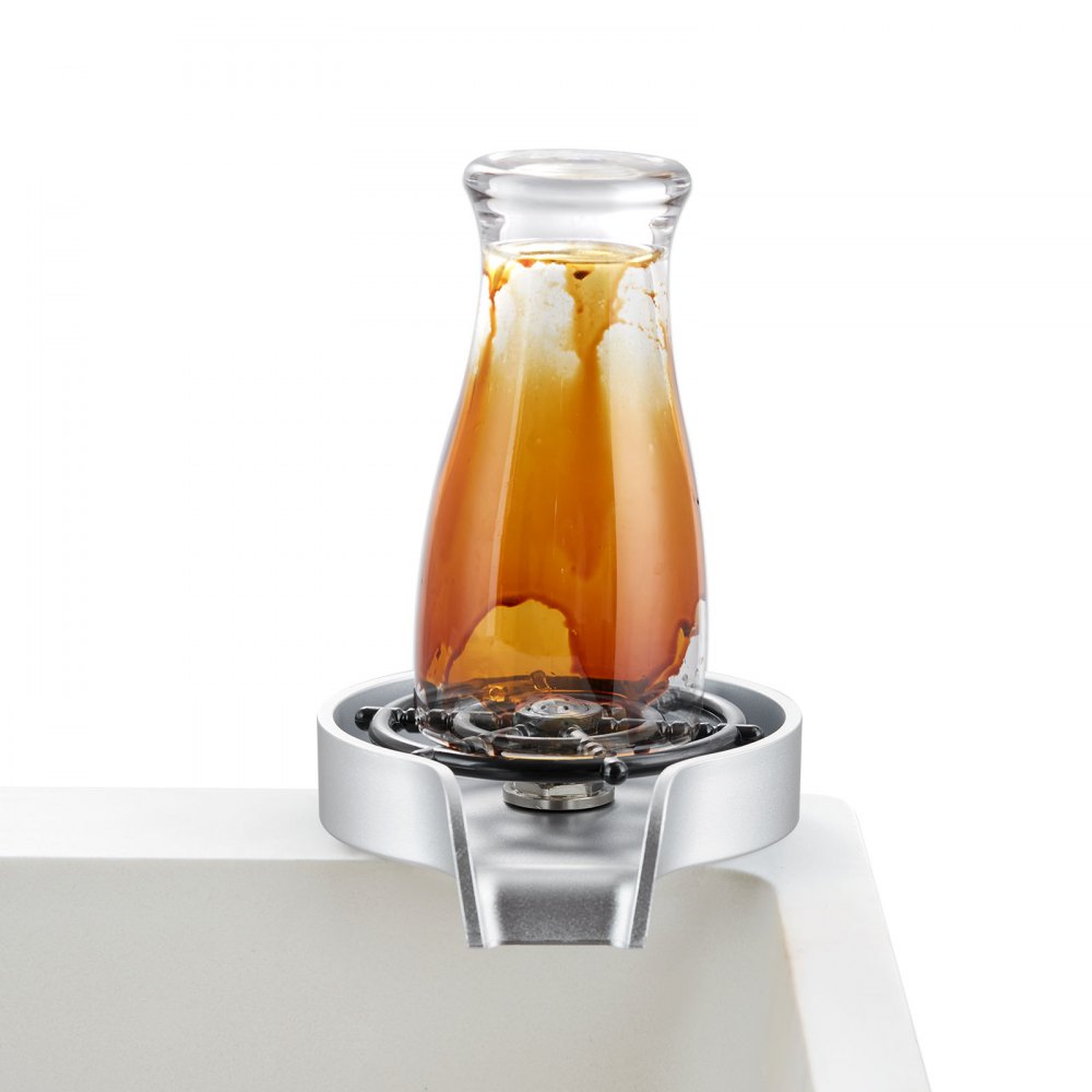 glass carafe on VEVOR glass rinser with brown liquid remnants.
