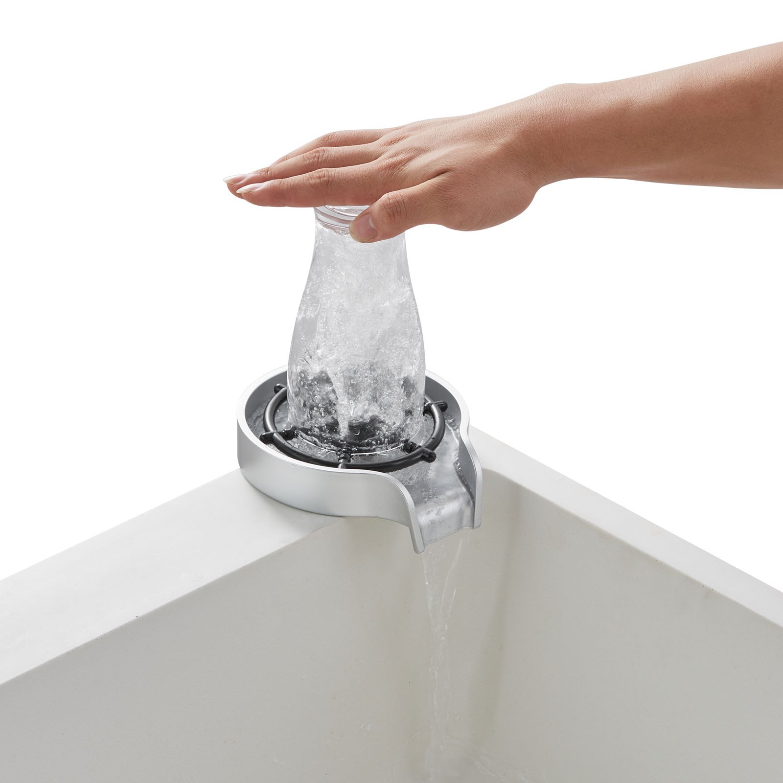 hand pressing a bottle on VEVOR glass rinser with water splashing and draining into sink.