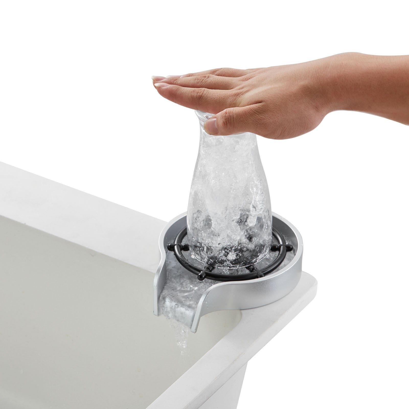 hand rinsing a glass bottle using a VEVOR glass rinser installed on a sink edge, water swirling inside.