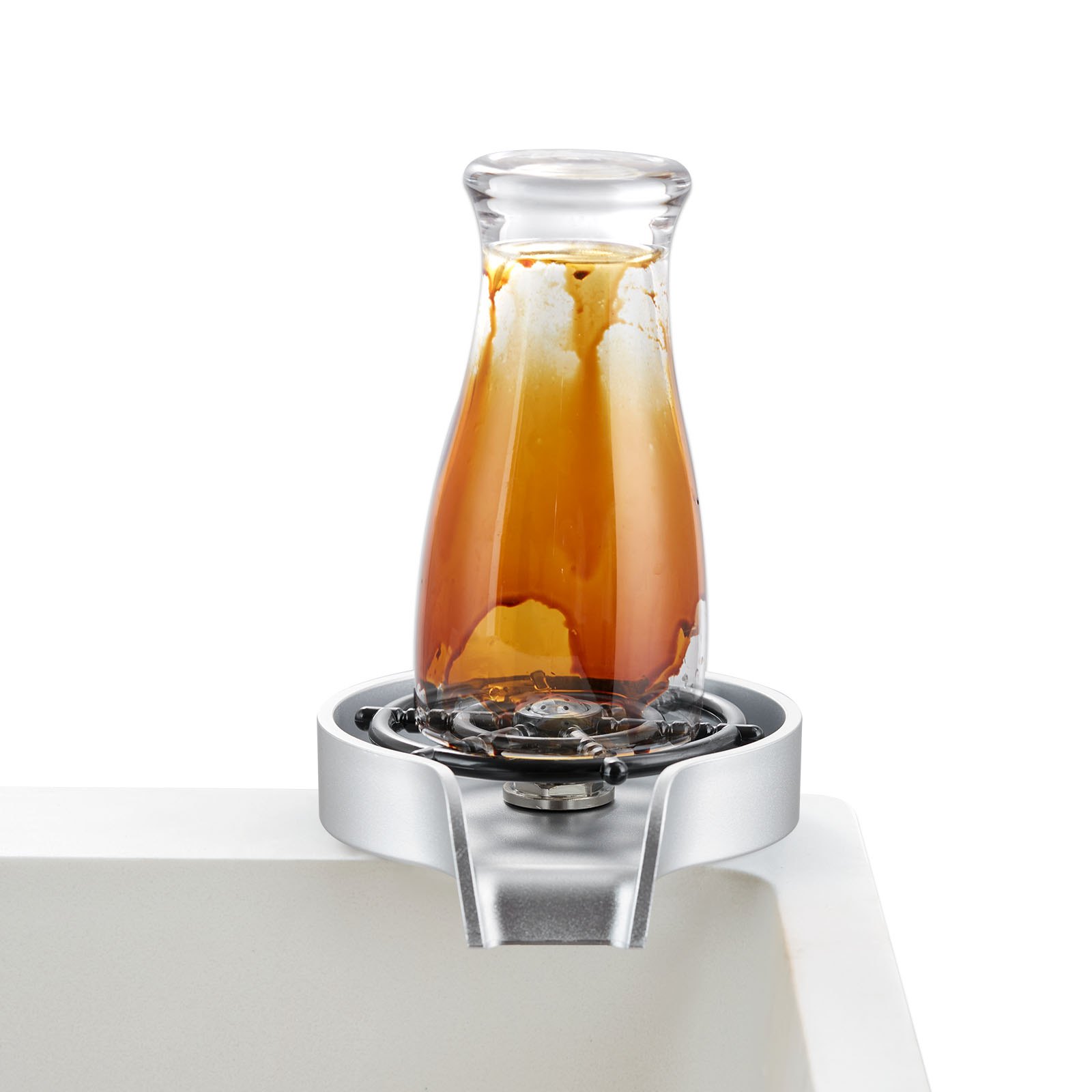 glass carafe on VEVOR glass rinser with brown liquid remnants.