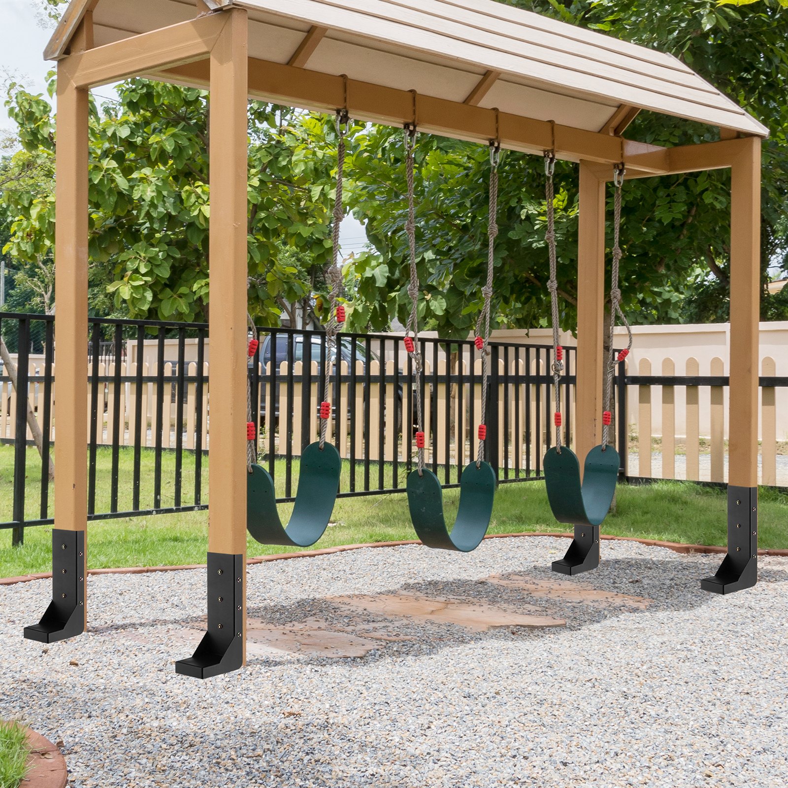playground swingset with VEVOR fence post anchor kit installed for secure anchoring on gravel surface.