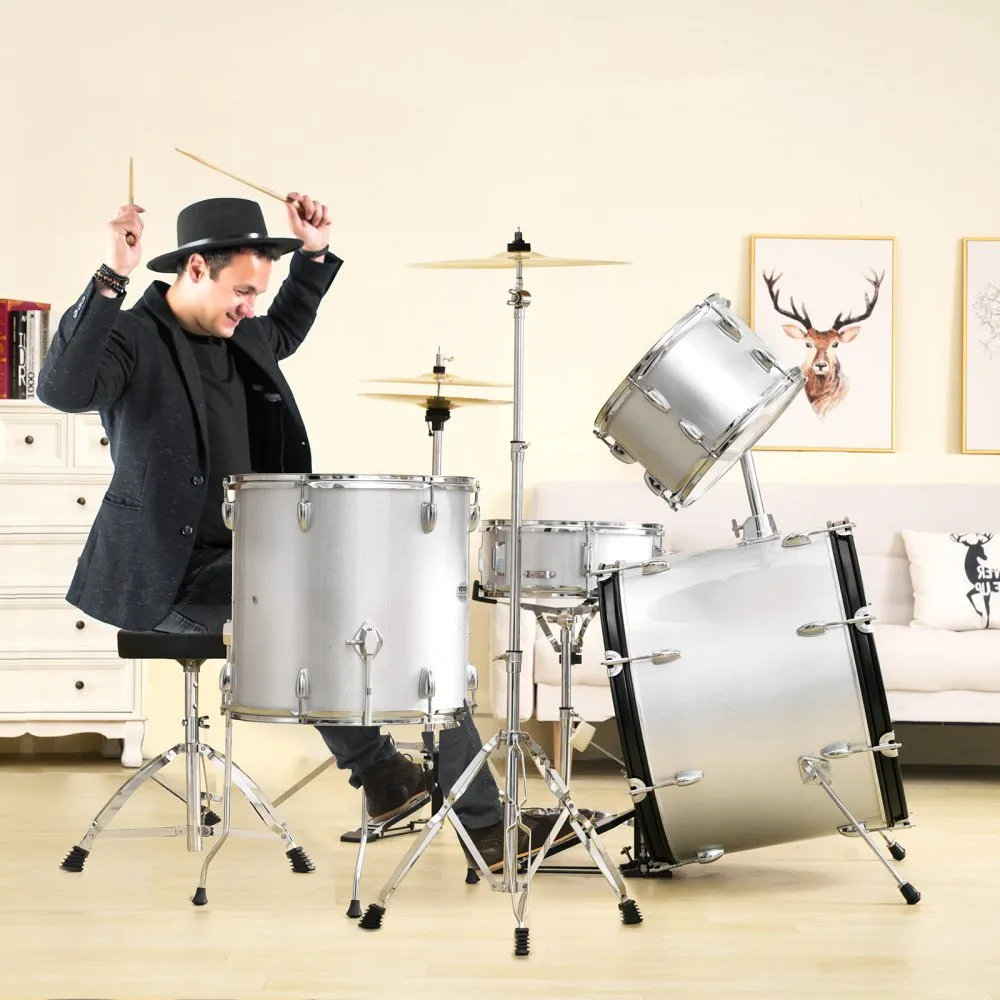 man playing a VEVOR adult drum set in a cozy living room with art on the walls.