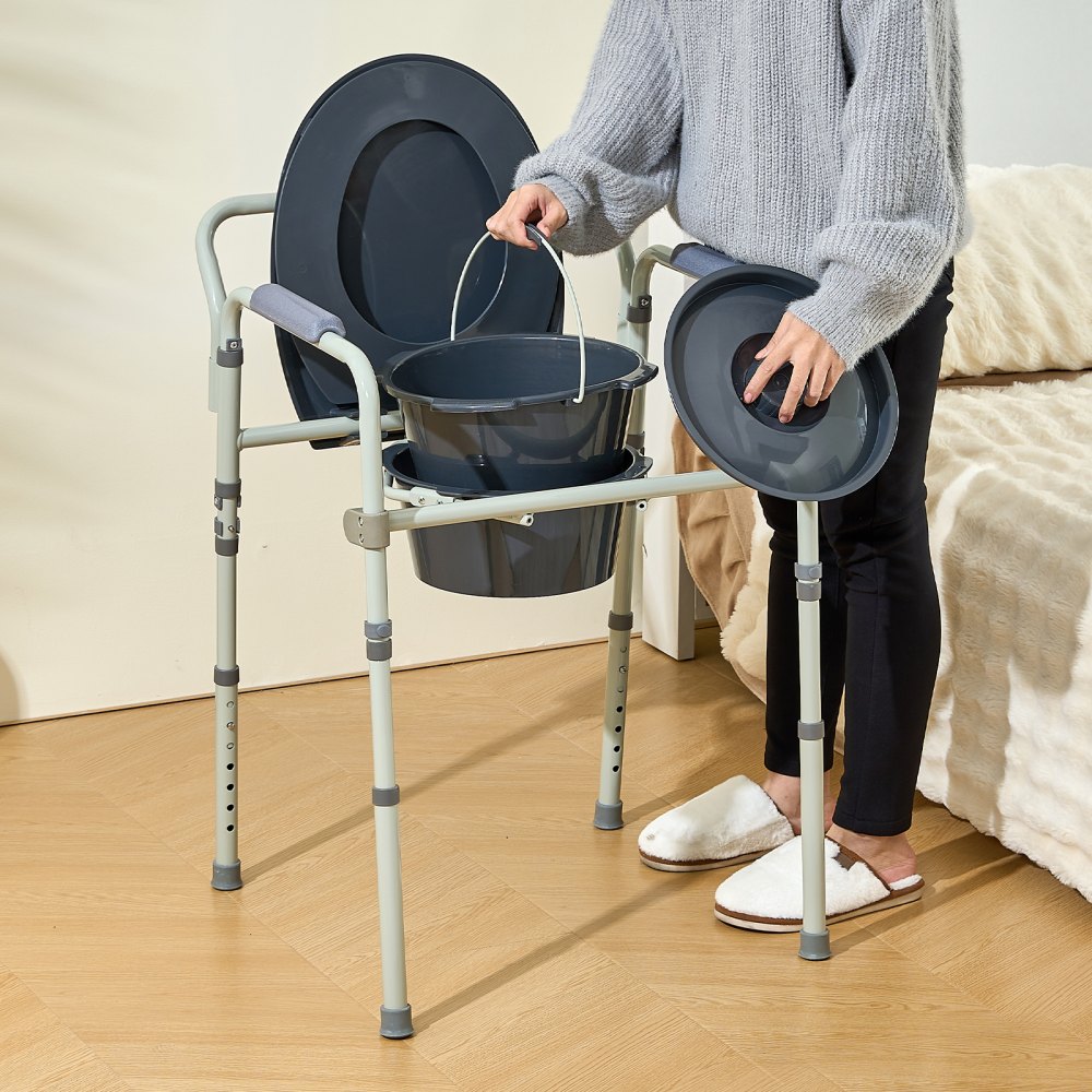 person assembling VEVOR commode chair beside a bed, holding a bucket and lid, showcasing its functionality.