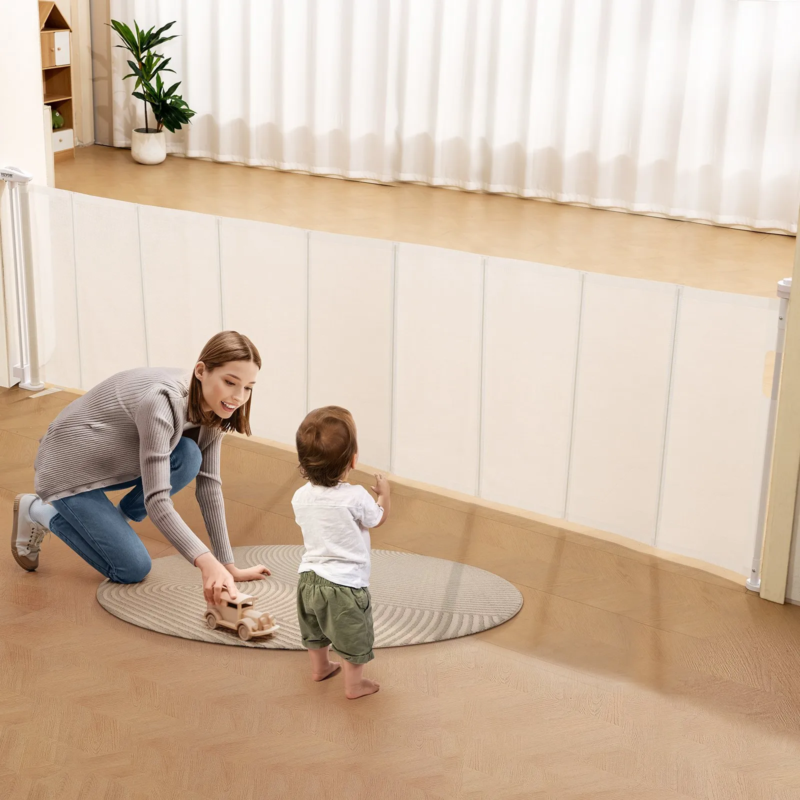 parent playing with child near VEVOR retractable baby gate in a bright room with wooden floors and plants.
