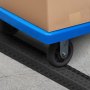 blue cart wheel crossing a VEVOR speed bump on a concrete surface, carrying a cardboard box.