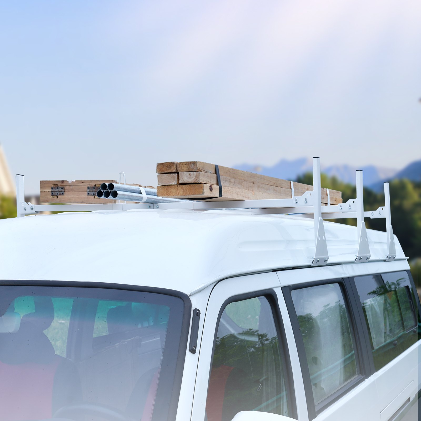 white van with VEVOR van ladder rack carrying wooden planks on the roof against a blurred background.