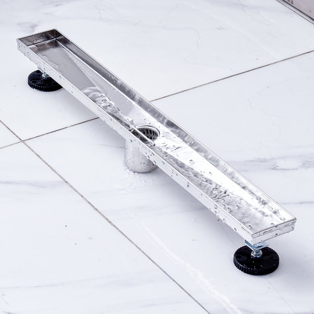 stainless steel VEVOR linear shower drain installed on white tile flooring.