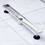 stainless steel VEVOR linear shower drain installed on white tile flooring.