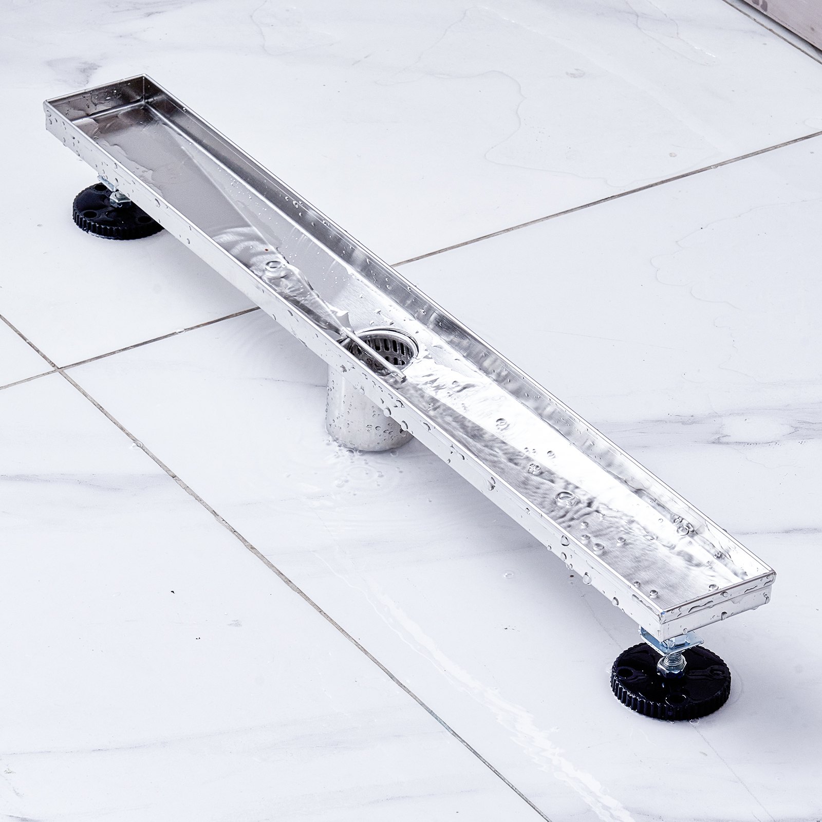 stainless steel VEVOR linear shower drain installed on white tile flooring.