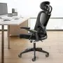 VEVOR ergonomic office chair in a modern office setting with a desk, computer, and large windows.
