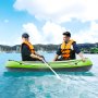 two people rowing a VEVOR inflatable fishing boat in clear blue water on a sunny day, wearing life vests.