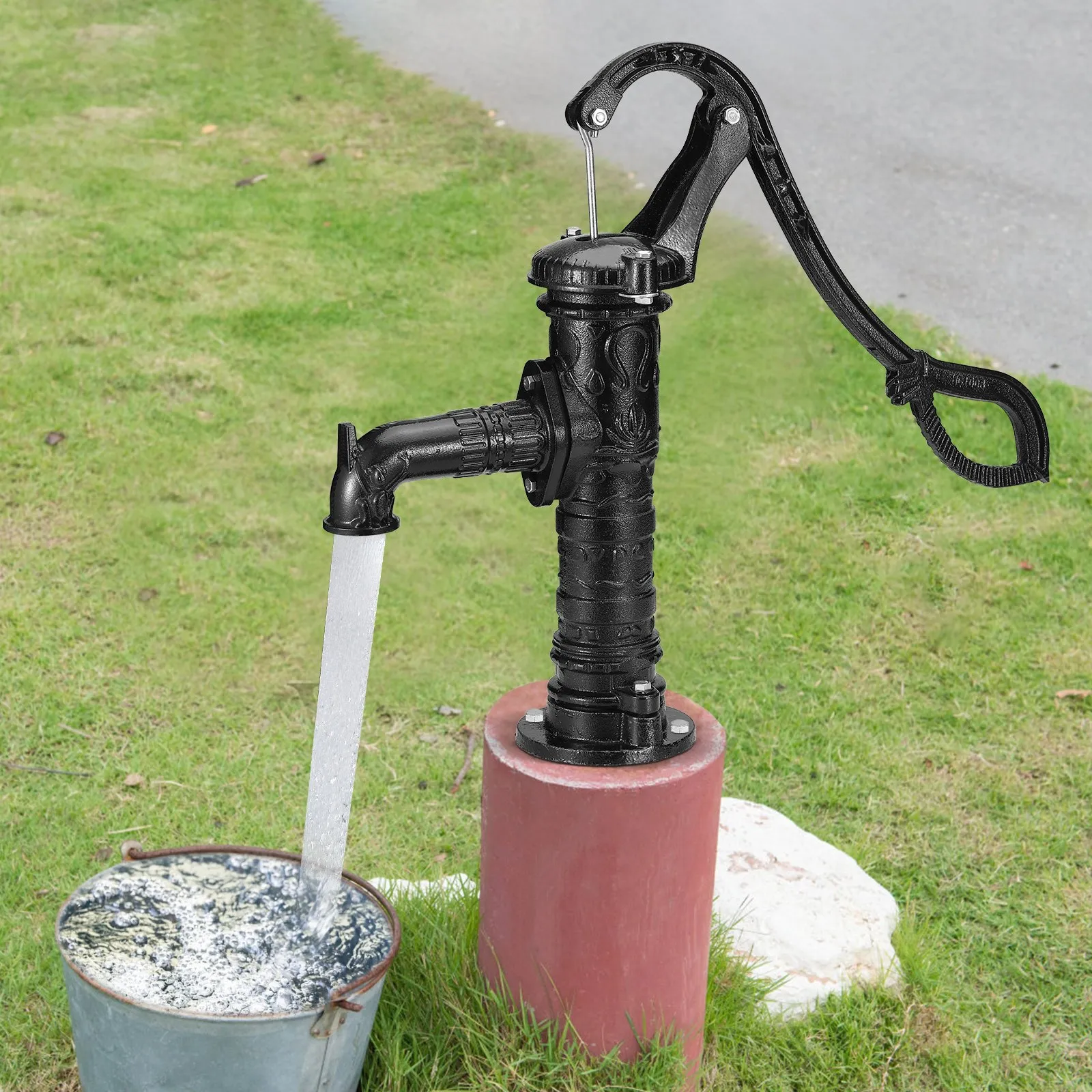black VEVOR antique hand water pump filling a bucket on green grass background.