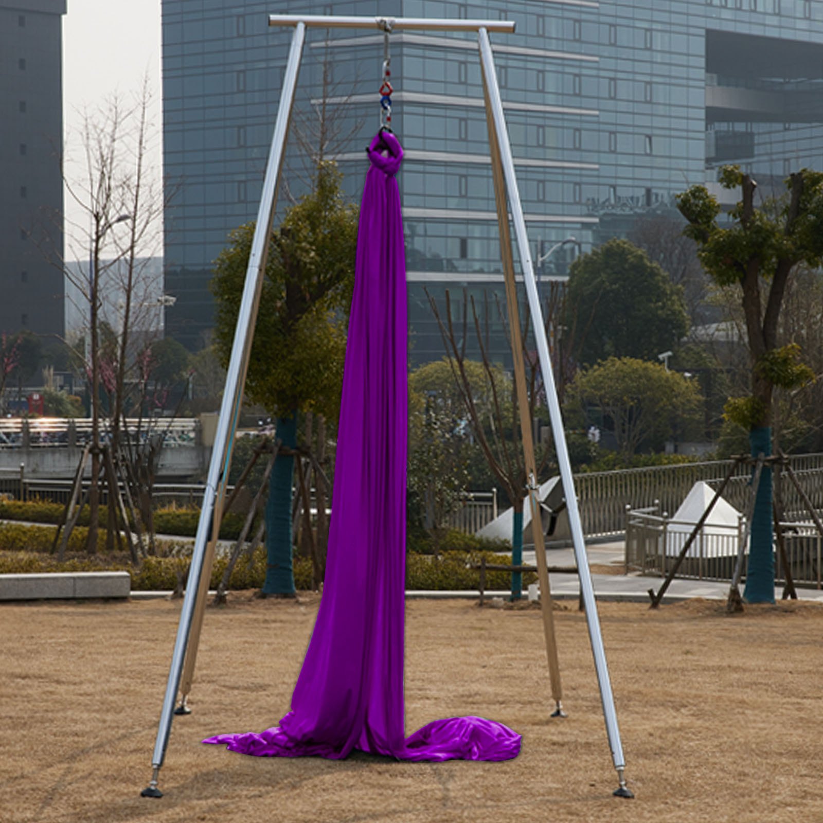 VEVOR yoga sling inversion setup in an urban outdoor park with buildings in the background.