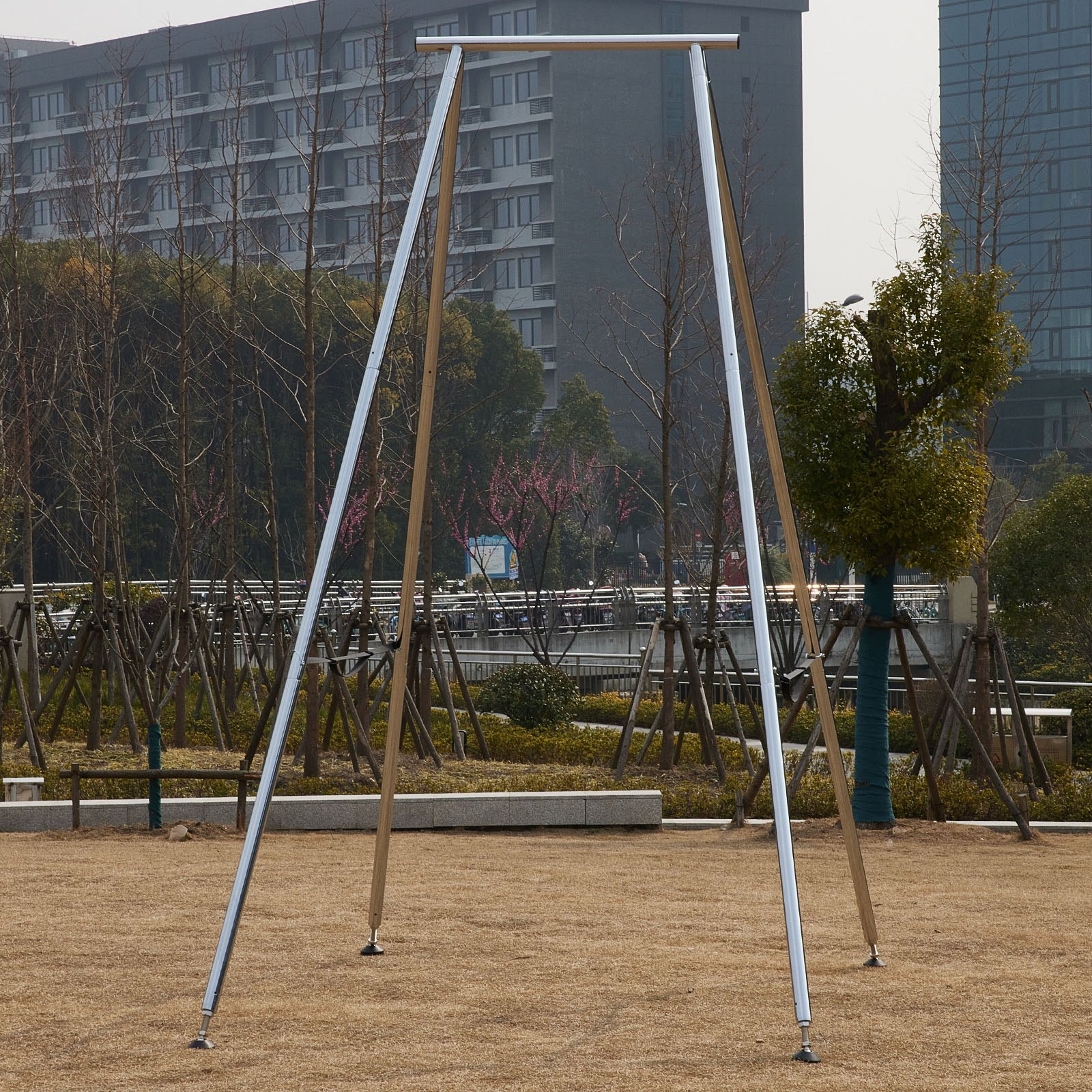 VEVOR aerial yoga frame set up outdoors with buildings and trees in the background.