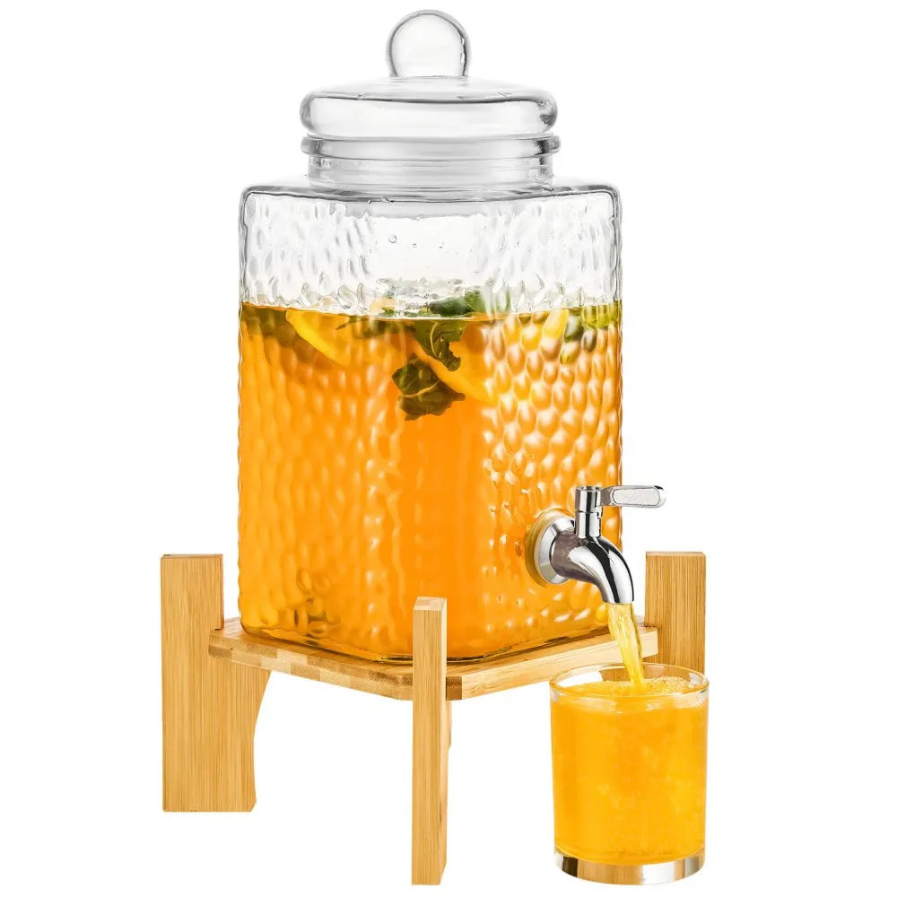 VEVOR beverage dispenser with glass container on bamboo stand, dispensing orange drink into a glass.