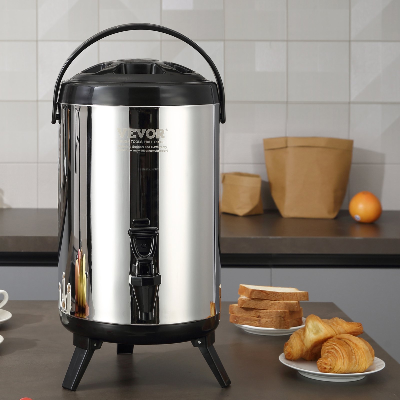 VEVOR beverage dispenser on a kitchen counter with bread, croissants, cups, and paper bags in the background.