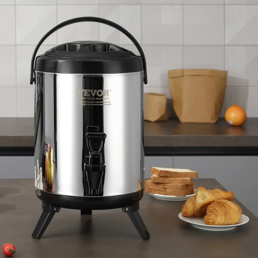 VEVOR stainless steel beverage dispenser on a kitchen counter with bread and croissants nearby.