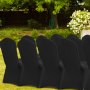 black VEVOR chair covers on outdoor chairs in a garden setting with green foliage and white flowers.