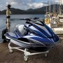 blue jet ski on a dock with mountains in the background, mounted on a VEVOR jet ski dolly.