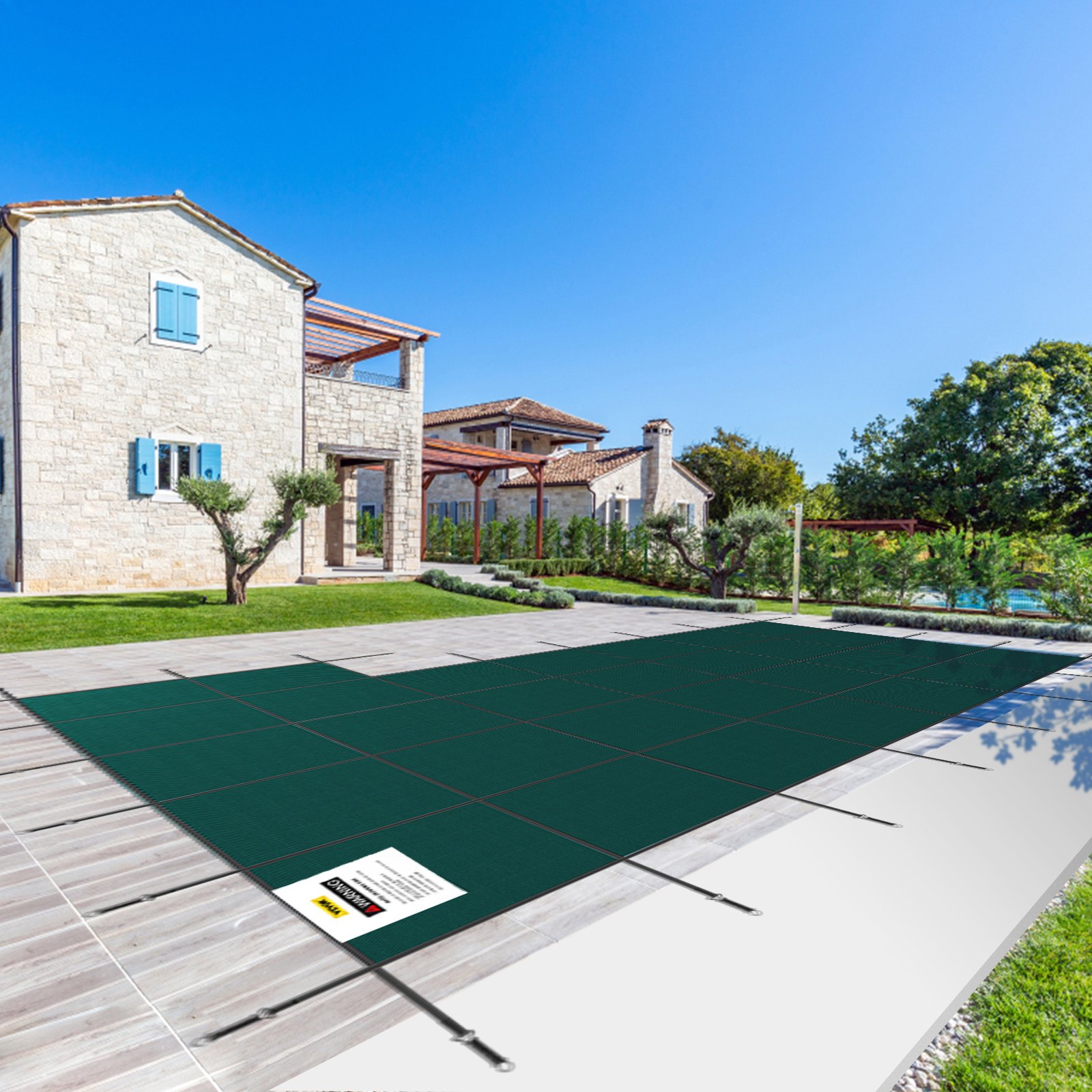 VEVOR pool safety cover on a sunny day over an outdoor pool with a villa and manicured garden.