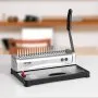 VEVOR binding machine on a desk with a handle and binding combs, ideal for office use.